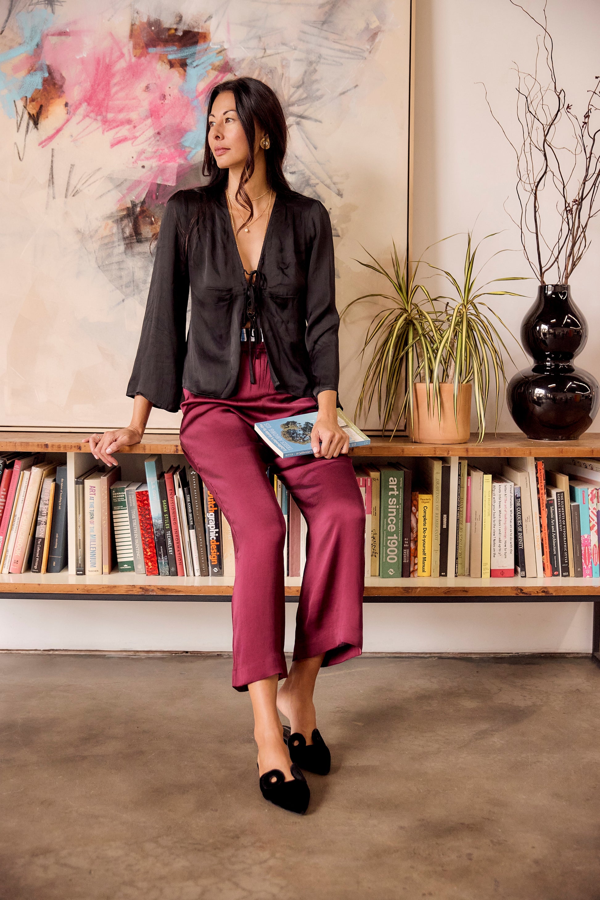 The Solune Muse Top Black — romantic black satin going-out blouse with adjustable lace-up front detail